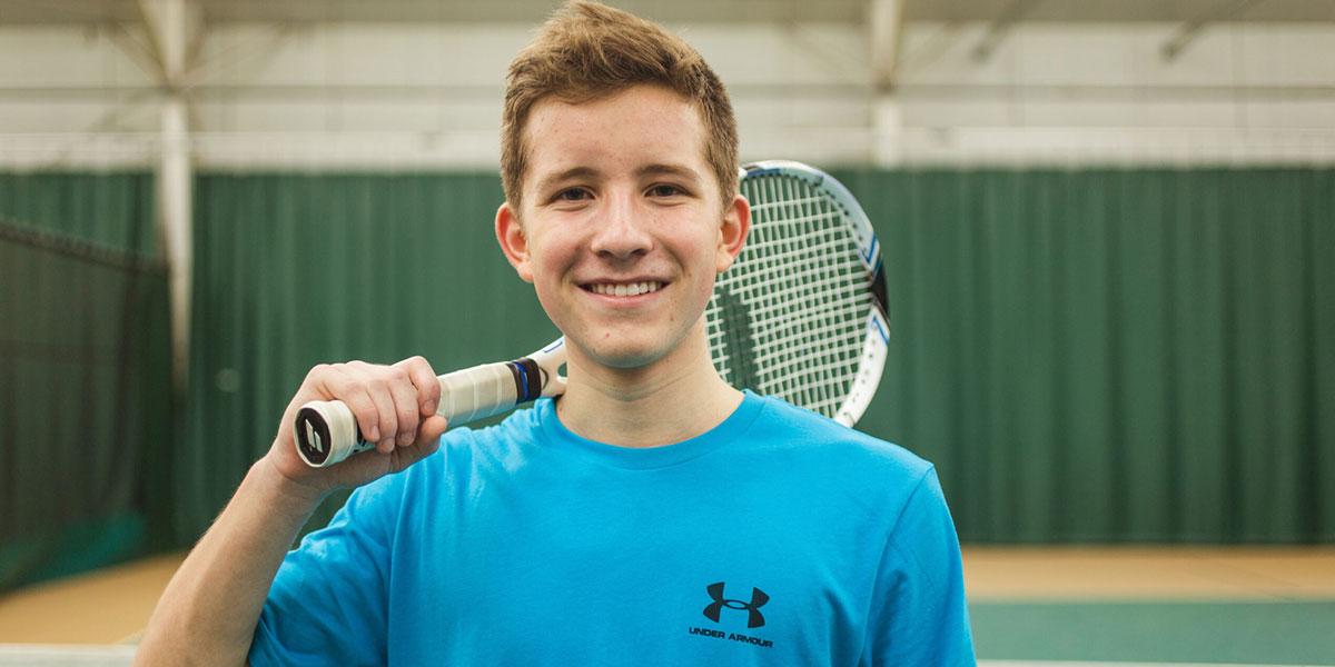 Teenager playing tennis at Parkside Fitness