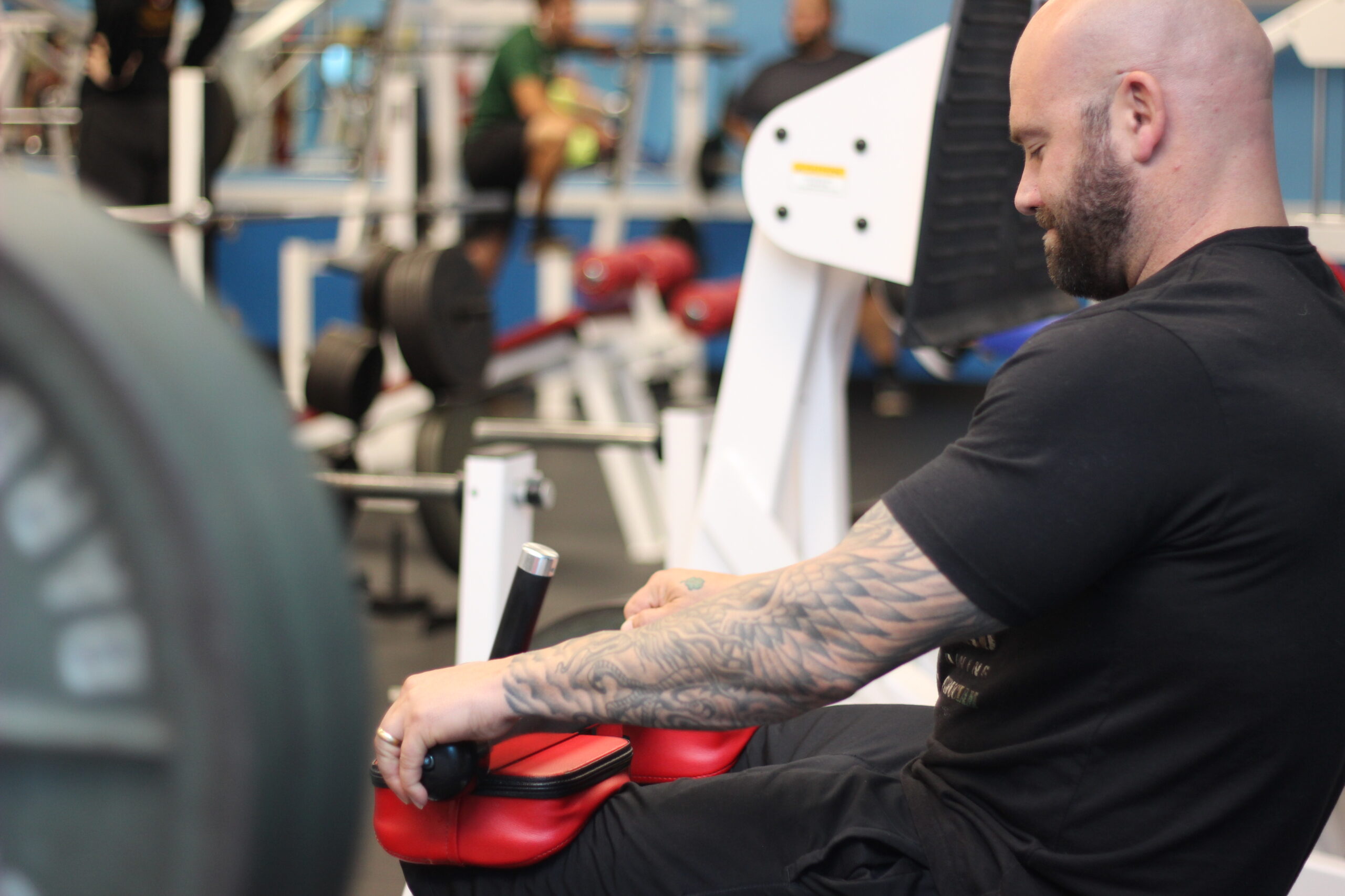 Bearded man using the weight equipment at Parkside