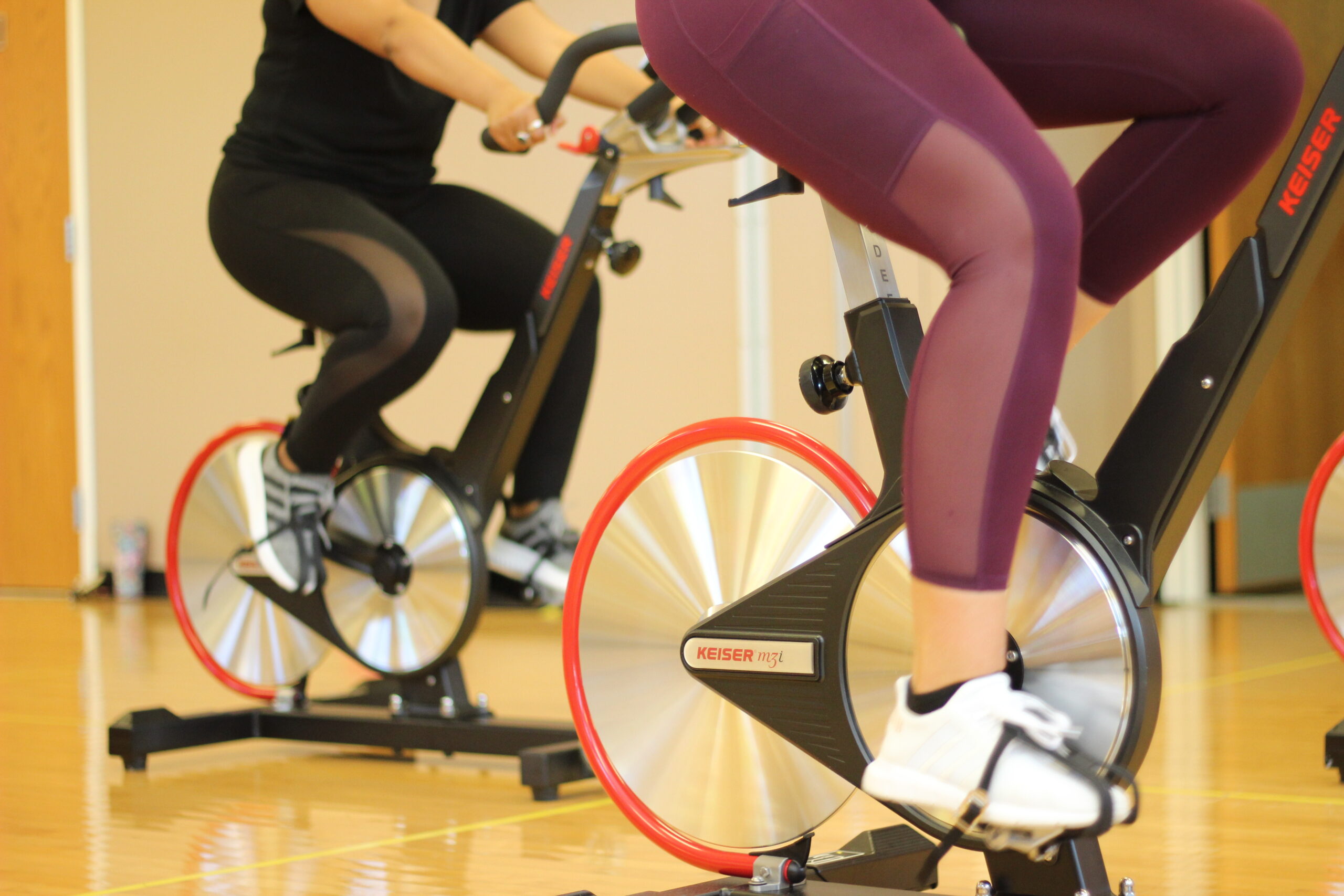 Two women on stationary bikes during a group class at Parkside Fitness