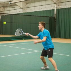 Teenage boy returning the tennis ball at Parkside Fitness