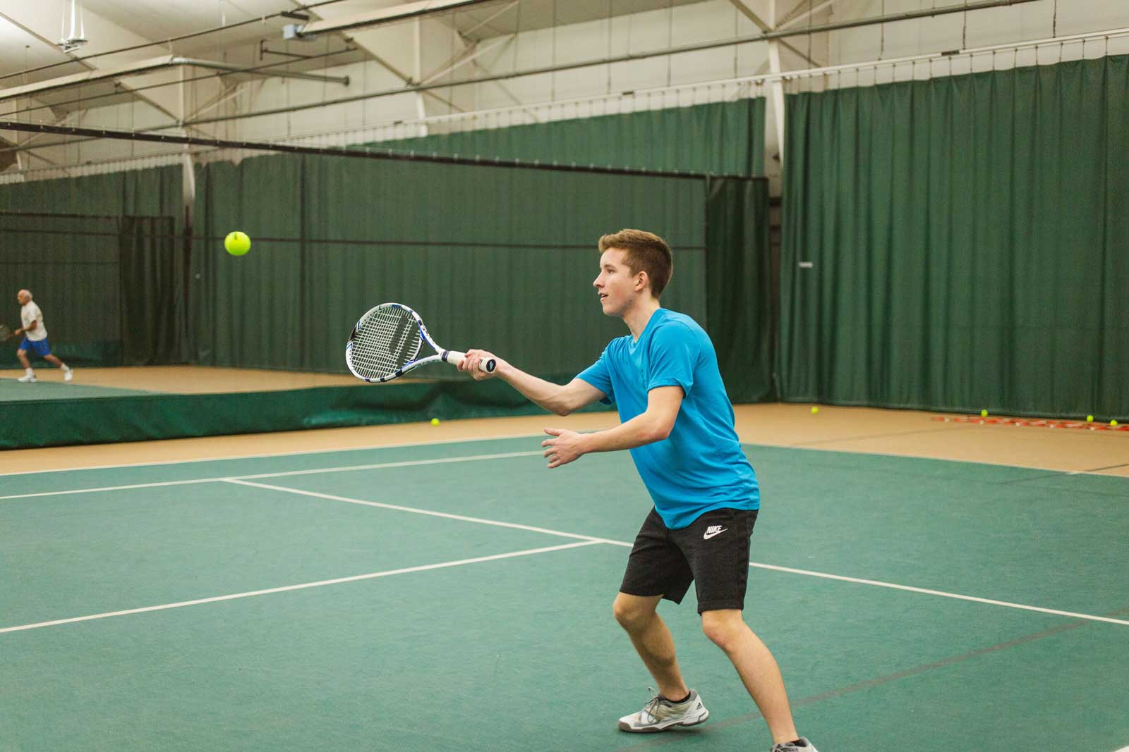 Teenage boy returning the tennis ball at Parkside Fitness