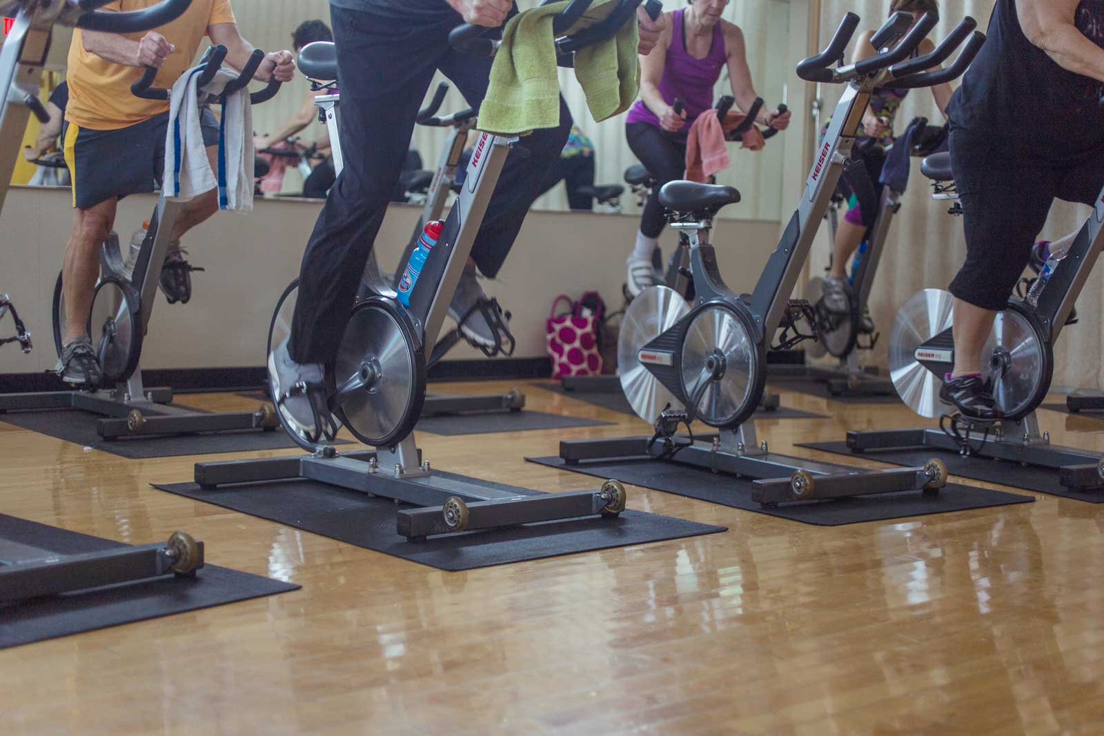 Group of people using stationary bikes during a class at Parkside Fitness