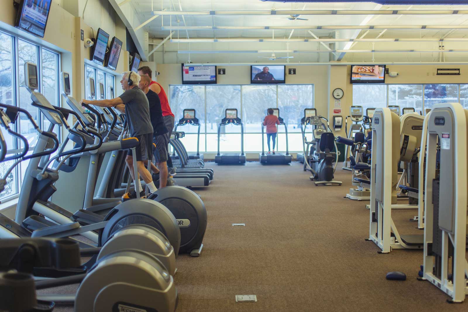 Three men using ellipticals at Parkside Fitness