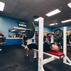 Man doing a bench press at Parkside Fitness