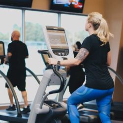 A man and a woman using ellipticals at Parkside Fitness