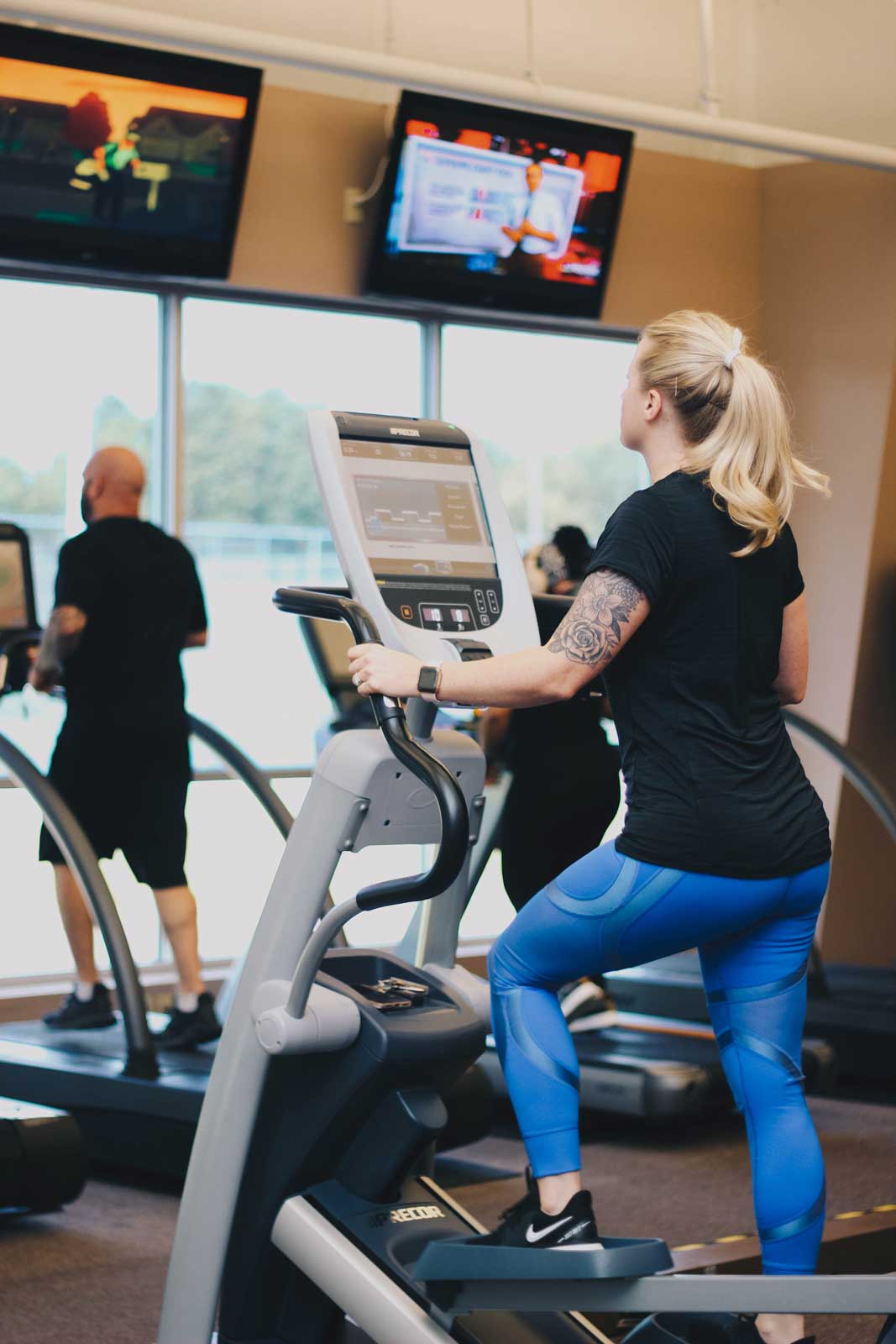 A man and a woman using ellipticals at Parkside Fitness