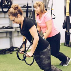 Woman using the weight room for body weight strength exercise