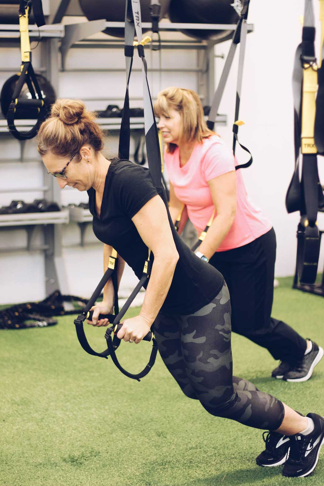 Woman using the weight room for body weight strength exercise