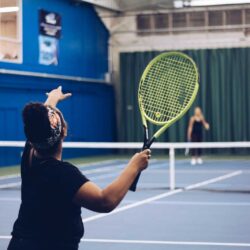 Woman serving at the Parkside Fitness tennis courts